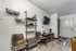 Studio living area at The Reserve at Rye 290 with seating, shelving, and TV setup.