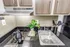 Studio kitchen at The Reserve at Rye 290 with sink, cooktop, and modern cabinetry.