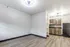 Open studio living area with modern flooring and kitchenette at The Reserve at Rye 290.