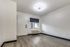 Studio living area with vinyl flooring, window, and front door at The Reserve at Rye 290.