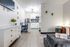 Modern interior with kitchenette, dining nook, dresser, and seating area at The Passages.