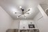 Modern ceiling light fixture above white kitchen cabinets.