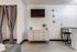 Studio interior with dresser space, wall-mount TV area, and bar seating section.