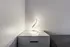 Soft lighting displayed on a bedside surface, highlighting the room&rsquo;s clean and modern finish.
