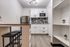 Open kitchen layout with built-in shelving, modern cabinets, and a compact prep area.