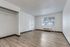 Open studio-style room with large window, closet space, and wood-style flooring.