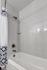 Shower and bathtub with tile surround.