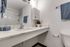 Bathroom vanity with sink, mirror, and countertop.