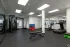 Spacious fitness center with cardio machines, strength equipment, and open floor area.