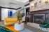 Stylish clubhouse lounge with seating, fireplace, and modern d&eacute;cor.