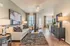 Inviting open-plan living area with stylish decor, cozy seating, and natural light-filled dining space.