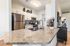 Modern kitchen with sleek stainless steel appliances, granite countertops, and elegant cabinetry, perfect for culinary creativity.