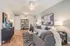 Elegant living room with modern decor, featuring a stylish sofa, contemporary artwork, and chic lighting.