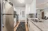 Modern kitchen with sleek stainless steel appliances, elegant granite countertops, and stylish cabinetry, offering a warm and inviting atmosphere.