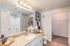 Elegant bathroom featuring a luxurious marble countertop, modern decor, and spacious walk-in closet.