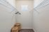 Spacious and bright walk-in closet with wire shelving and natural light, perfect for stylish storage solutions.