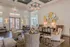 Elegant apartment lounge with plush seating, modern decor, and a large chandelier exuding luxury and comfort.