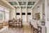 Elegant community room with modern decor, featuring ample seating, natural light from large windows, and contemporary ceiling design.