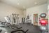 Modern fitness center featuring state-of-the-art exercise equipment, free weights, and vibrant exercise balls, perfect for a dynamic workout experience.