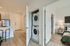 Chic apartment interior featuring modern kitchen, in-unit laundry, and cozy bedroom with stylish decor.