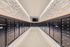 Modern mailroom with sleek black mailboxes and stylish geometric wall design.
