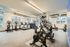 Modern fitness center featuring state-of-the-art exercise equipment, large windows for natural light, and sleek contemporary design.