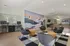 Contemporary lounge area with vibrant mural, stylish seating, and workspace, ideal for socializing and productivity.