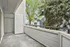 Inviting open balcony with serene views of lush greenery and modern architectural details.