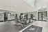 Spacious and modern fitness center with high-quality exercise equipment and bright natural lighting.