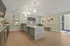 Modern apartment interior featuring a stylish lounge area with chic lighting, sleek countertops, and contemporary artwork.