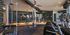 Modern gym with state-of-the-art equipment, chic design, and ample natural light; ideal for fitness enthusiasts.