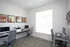 Bright and modern office space with sleek desks, ergonomic chairs, and vibrant artwork, perfect for productivity.