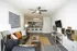 Contemporary open-plan living space with stylish furniture, vibrant accents, and a modern kitchen, perfect for urban living.