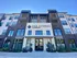 Modern apartment building front with elegant stone and brick facade, featuring stylish balconies at The Fitzroy Promenade.