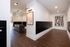 Sophisticated mailroom featuring sleek black mailboxes and contemporary artwork with elegant lighting.