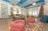 Vibrant living area featuring colorful geometric rugs, stylish modern seating, and a festive holiday tree, offering a lively and welcoming atmosphere.
