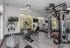 Modern fitness center with advanced gym equipment, bright natural lighting, and stylish decor offering an invigorating workout environment.