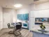 Contemporary kitchen and dining area with sleek decor, featuring modern art, stylish table settings, and chic cabinetry.