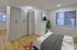 Modern bedroom with sleek wardrobes, cozy bed, and large window offering natural light.