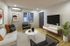 Modern and inviting living room featuring sleek furniture, stylish decor, and a mounted flat-screen TV, perfect for relaxation and entertainment.