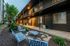 Charming apartment complex exterior with modern design, cozy lighting, and inviting outdoor seating area.