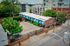 Charming apartment complex with colorful geometric murals and lush greenery in an urban setting.