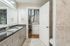 Elegant bathroom with modern fixtures, granite countertops, and convenient in-unit laundry area.