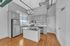 Chic modern kitchen with stainless steel appliances, elegant cabinetry, and hardwood floors showcasing a sleek design.