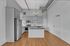 Elegant modern kitchen with sleek stainless steel appliances, an inviting island, and polished hardwood floors.