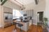 Bright and modern kitchen with stainless steel appliances, elegant cabinetry, and a spacious island, offering a perfect blend of style and functionality.