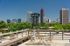 Charming rooftop terrace with vintage furniture and panoramic views of a vibrant city skyline.
