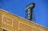 Charming vintage hotel sign atop a brick building under a clear blue sky.
