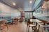Chic and inviting room featuring stylish wallpaper, modern furniture, and elegant dining area with a cozy ambiance.