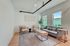 Bright and modern living room with sleek furniture, stylish decor, and large windows allowing natural light, perfect for cozy gatherings.